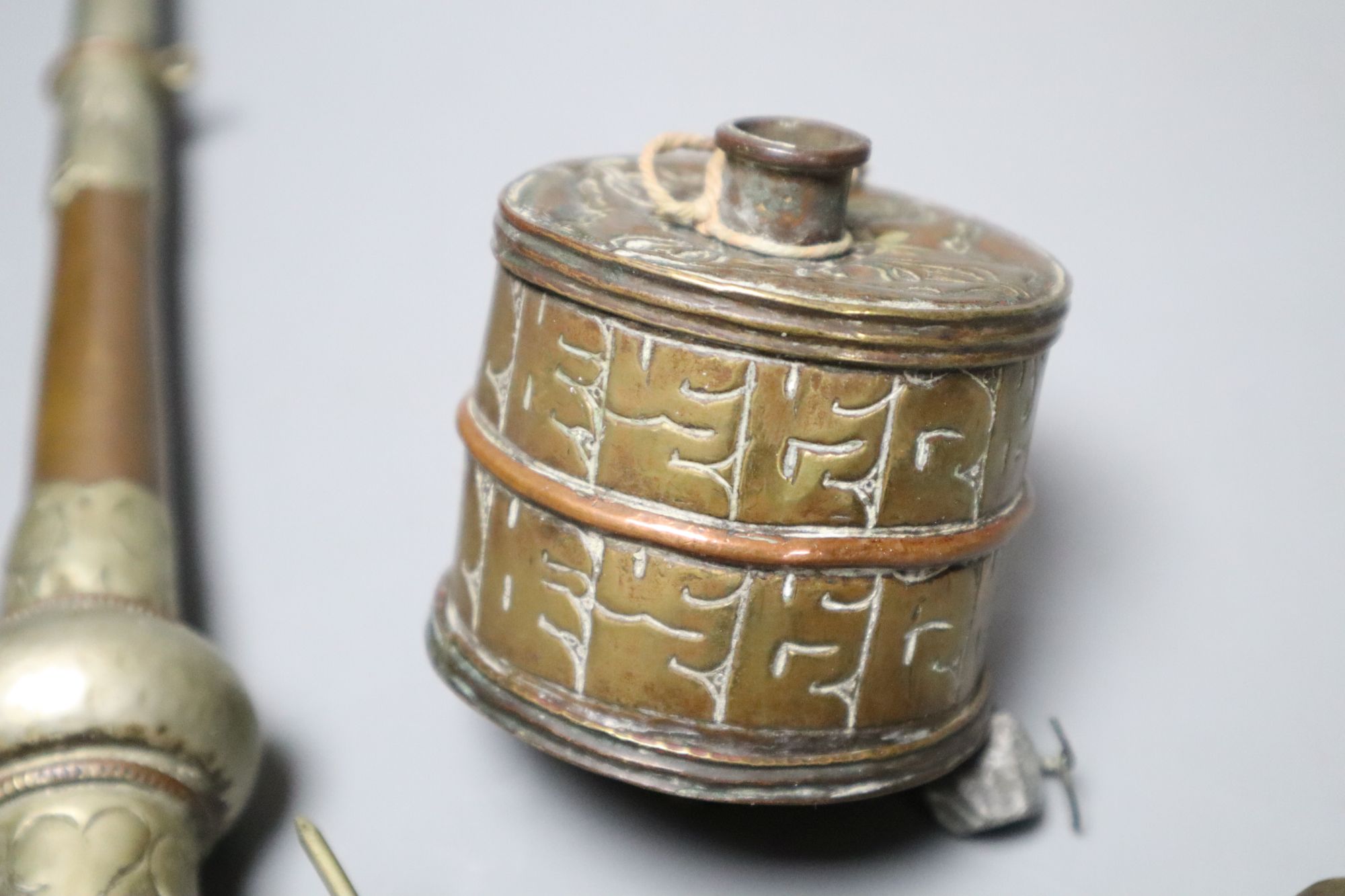 A Himalayan Buddhist brass trumpet and two prayer wheels